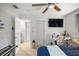 View of bedroom featuring a desk, mounted TV, closet, and doorways to other rooms at 1143 Ne 23Rd St, Ocala, FL 34470