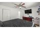 Comfortable bedroom features a ceiling fan, closet, and dresser at 1143 Ne 23Rd St, Ocala, FL 34470