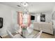 Dining area with a modern glass table, white chairs, and stylish decor accents at 1143 Ne 23Rd St, Ocala, FL 34470