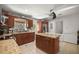 Well-lit kitchen features granite countertops, wood cabinets, a ceiling fan, and stainless-steel appliances at 1143 Ne 23Rd St, Ocala, FL 34470