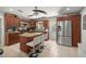 Spacious kitchen with stainless steel appliances, island with bar stools and wood cabinets at 1143 Ne 23Rd St, Ocala, FL 34470