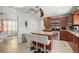 Kitchen featuring an island with bar stools, stainless steel appliances, and tile flooring at 1143 Ne 23Rd St, Ocala, FL 34470