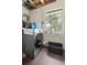 Laundry room with a washer, dryer, window, and black plastic basket at 1143 Ne 23Rd St, Ocala, FL 34470