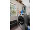 Laundry room with a washer, dryer, window, and black plastic basket at 1143 Ne 23Rd St, Ocala, FL 34470