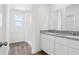 Bright bathroom featuring double vanity with granite countertop and wood-look flooring at 2222 Oklahoma Dr, Sumterville, FL 33585