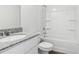 Bathroom with granite countertops, white cabinets, and shower-tub combo at 2222 Oklahoma Dr, Sumterville, FL 33585