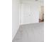 Bedroom featuring neutral carpeting, white walls, and a door leading to another part of the home at 2222 Oklahoma Dr, Sumterville, FL 33585