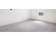 Bedroom with neutral carpeting, white walls, and a bright window showing a nice view at 2222 Oklahoma Dr, Sumterville, FL 33585