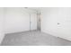 Bedroom with neutral carpeting, white walls, and a closed door to the room's entrance at 2222 Oklahoma Dr, Sumterville, FL 33585