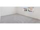 This empty bedroom has plush carpeting and large windows providing ample natural light at 2222 Oklahoma Dr, Sumterville, FL 33585
