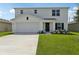 Charming two-story home with a well-manicured lawn and a two car garage in a suburban neighborhood at 2222 Oklahoma Dr, Sumterville, FL 33585