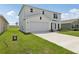 Two-story home with a two car garage, green lawn, and visible utility boxes on the side of the house at 2222 Oklahoma Dr, Sumterville, FL 33585