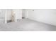 Hallway with neutral carpet, white walls, and white doors leading to other areas of the house at 2222 Oklahoma Dr, Sumterville, FL 33585