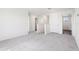 Hallway with neutral carpet, white walls, and white doors leading to various rooms in the home at 2222 Oklahoma Dr, Sumterville, FL 33585