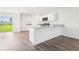 Bright kitchen features white cabinetry, stainless steel appliances and granite countertops at 2222 Oklahoma Dr, Sumterville, FL 33585