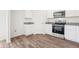 This kitchen features stainless steel appliances, granite countertops, and white cabinets at 2222 Oklahoma Dr, Sumterville, FL 33585