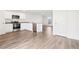 Modern kitchen with stainless steel appliances, granite countertops, and wood-look floors with ample counter space at 2222 Oklahoma Dr, Sumterville, FL 33585