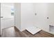The laundry room has wood-look floors, white walls, and access to hookups for laundry machines at 2222 Oklahoma Dr, Sumterville, FL 33585