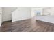 Open-concept layout with wood-look floors connecting the living and dining areas, with a staircase visible at 2222 Oklahoma Dr, Sumterville, FL 33585