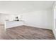 Open living space featuring wood-look flooring and a granite counter top bar area at 2222 Oklahoma Dr, Sumterville, FL 33585