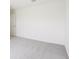 An empty bedroom with plush carpet and a single window at 2228 Oklahoma Dr, Sumterville, FL 33585