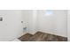 Laundry room features white walls, and wood-look vinyl floors at 2228 Oklahoma Dr, Sumterville, FL 33585