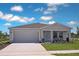 Charming single-story home featuring a two-car garage, well-manicured lawn, and inviting front porch at 2383 Oklahoma Dr, Sumterville, FL 33585