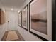 Inviting hallway with decorative artwork and wood-look flooring, creating a stylish and welcoming entrance at 2383 Oklahoma Dr, Sumterville, FL 33585