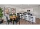 Kitchen and dining area featuring a granite counter top, breakfast bar with seating, and wood-look flooring at 2383 Oklahoma Dr, Sumterville, FL 33585