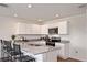 Modern kitchen with white cabinets, stainless steel appliances, granite countertops, and a breakfast bar at 2383 Oklahoma Dr, Sumterville, FL 33585