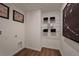 Practical laundry room with shelves, perfect for organizing laundry essentials, and vinyl floors for ease of cleaning at 2383 Oklahoma Dr, Sumterville, FL 33585