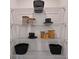 Well-organized pantry shelves featuring clear containers and black baskets for easy storage and accessibility at 2383 Oklahoma Dr, Sumterville, FL 33585