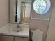 Bathroom with a vanity sink, toilet, and round window at 1152 Mccormick Dr, Deltona, FL 32725