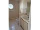 Bathroom with vanity, mirror, and round window at 1152 Mccormick Dr, Deltona, FL 32725