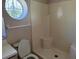 Bathroom features a standing shower and a unique round window at 1152 Mccormick Dr, Deltona, FL 32725