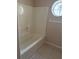 Clean bathroom with a shower-tub combo and a round window at 1152 Mccormick Dr, Deltona, FL 32725