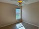 Bedroom features a ceiling fan and large, window with security bars at 1152 Mccormick Dr, Deltona, FL 32725