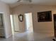 Spacious bedroom featuring neutral walls, tile flooring, and doorways leading to other rooms at 1152 Mccormick Dr, Deltona, FL 32725
