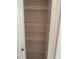 Empty storage closet with shelving and a white door, ready for organizing and storage at 1152 Mccormick Dr, Deltona, FL 32725