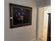 Hallway featuring an ornate floral painting and view into adjacent room at 1152 Mccormick Dr, Deltona, FL 32725