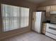 Bright kitchen with large window, white refrigerator, stove, and tile flooring at 1152 Mccormick Dr, Deltona, FL 32725