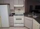 Functional kitchen with white appliances and cabinetry offers a practical space for meal preparation at 1152 Mccormick Dr, Deltona, FL 32725