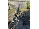 Backyard cherub statue on a stone pillar against a wooden fence and green foliage backdrop at 1152 Mccormick Dr, Deltona, FL 32725