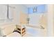 Bright bathroom with a tub, toilet, and beachy decor at 1183 Ocean Shore Blvd # 5050, Ormond Beach, FL 32176