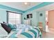 Guest bedroom with a king-size bed and teal accents at 1183 Ocean Shore Blvd # 5050, Ormond Beach, FL 32176