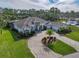 Luxury home with circular driveway, landscaped yard, and tile roof at 109 La Toscana Rotonda, Ormond Beach, FL 32174