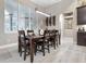 Bright dining room features a wood table and chairs,wine rack and large window at 109 La Toscana Rotonda, Ormond Beach, FL 32174