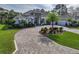 Two-story home with tile roof, landscaping, and paver driveway at 109 La Toscana Rotonda, Ormond Beach, FL 32174