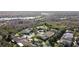 An aerial view showcasing the location of the neighborhood near local lakes, with a backdrop of lush greenery at 112 Sevilla Ct, Poinciana, FL 34759