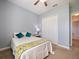 Simple bedroom featuring a comfortable bed, a closet, and carpet flooring at 112 Sevilla Ct, Poinciana, FL 34759